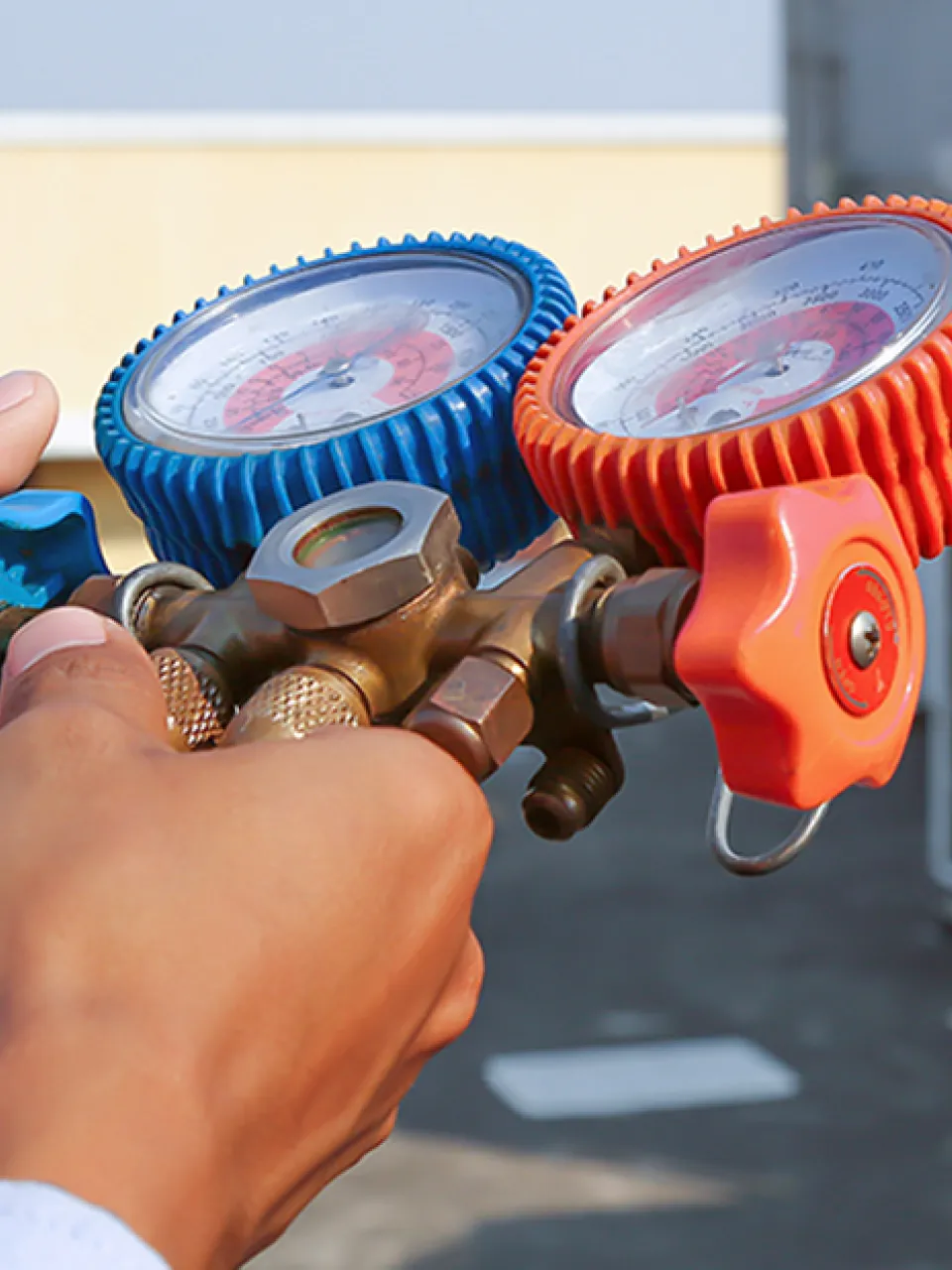 Technician performing freon-coolant service during an air conditioning maintenance in Sarasota