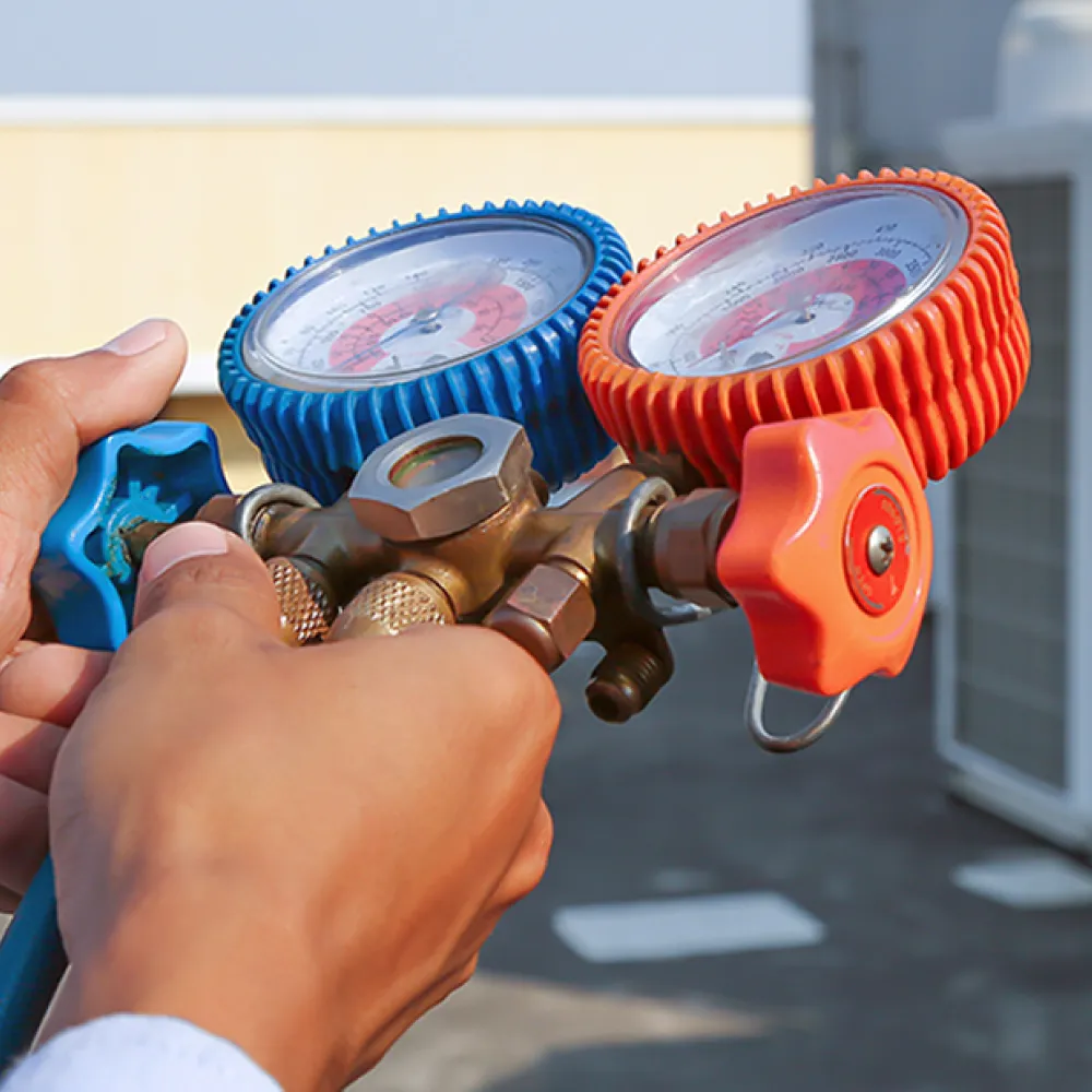 Technician performing freon-coolant service during an air conditioning maintenance in Sarasota